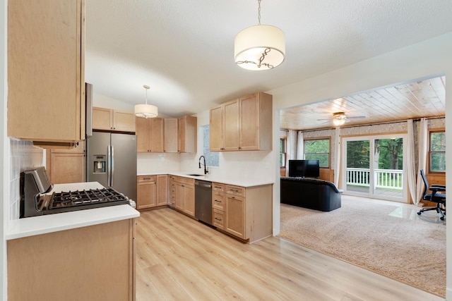 18799 147th St NW, Elk River, MN 55330 - kitchen featuring stainless steel appliances, light brown cabinets, open floor plan, a sink, and vaulted ceiling