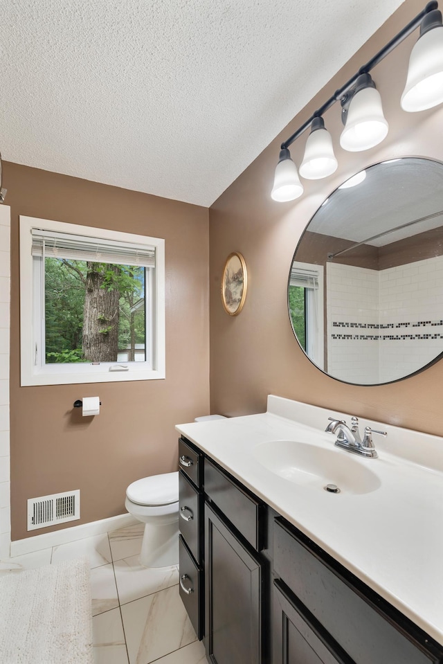 18799 147th St NW, Elk River, MN 55330 - bathroom featuring toilet, vanity, a textured ceiling, and a shower