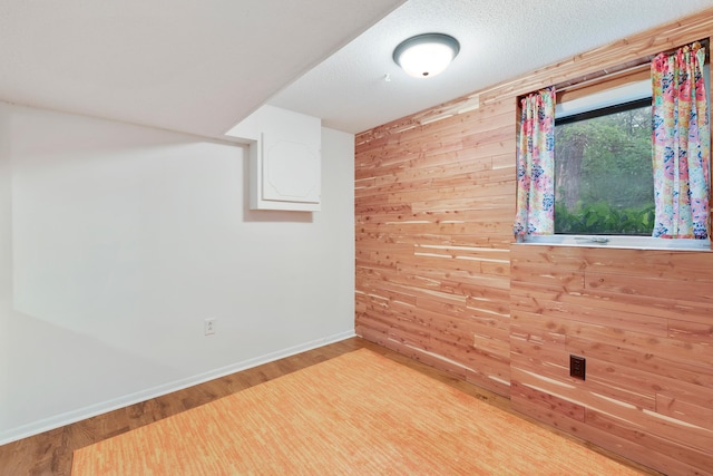 18799 147th St NW, Elk River, MN 55330 - empty room featuring wood walls, wood finished floors, and baseboards