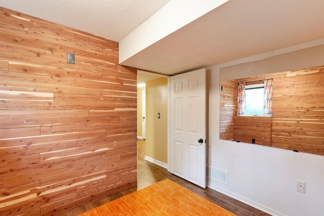18799 147th St NW, Elk River, MN 55330 - empty room with wooden walls, wood finished floors, a textured ceiling, and baseboards