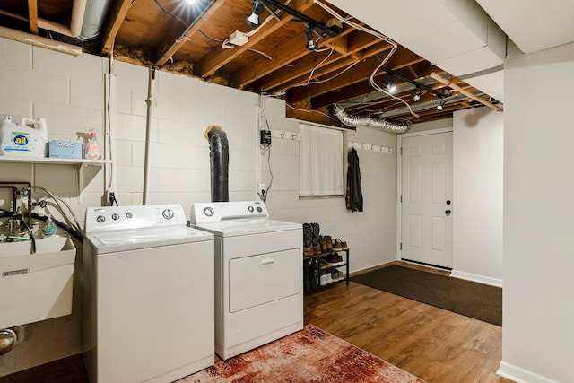 18799 147th St NW, Elk River, MN 55330 - laundry area featuring independent washer and dryer, wood finished floors, concrete block wall, and baseboards