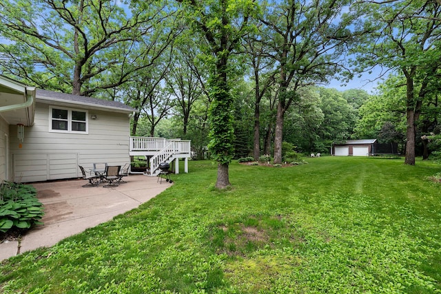 18799 147th St NW, Elk River, MN 55330 - view of grassy yard with a deck, a patio area, a garage, and an outdoor structure