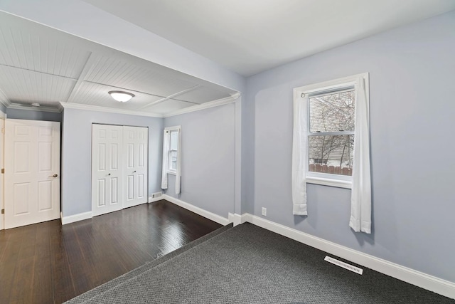 724 1st Ave NW, New Brighton, MN 55112 - unfurnished bedroom with baseboards, hardwood / wood-style floors, crown molding, and a closet