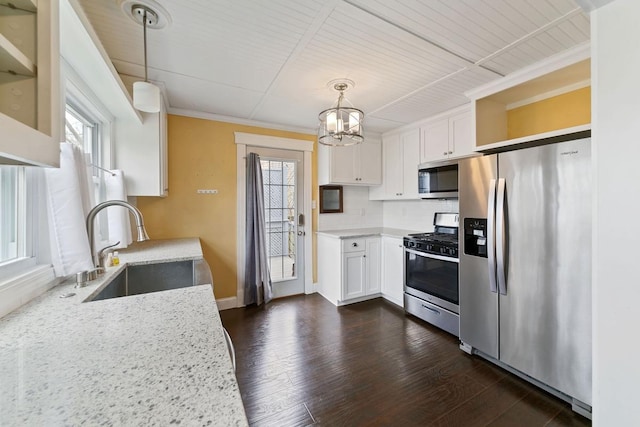 724 1st Ave NW, New Brighton, MN 55112 - kitchen featuring stainless steel appliances, a sink, a chandelier, white cabinets, and crown molding
