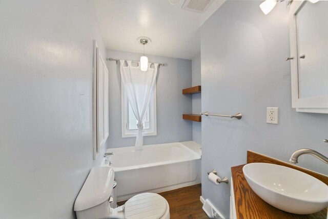 724 1st Ave NW, New Brighton, MN 55112 - full bath with toilet, a bath, vanity, and wood finished floors