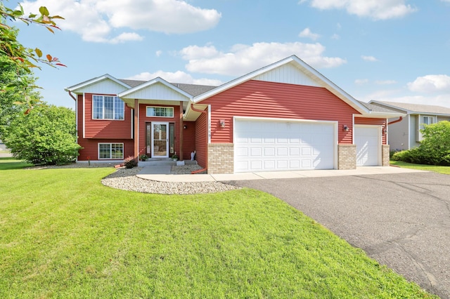 12966 Carole Dr, Becker, MN 55308 - view of front facade with brick siding, a front yard, an attached garage, and asphalt driveway