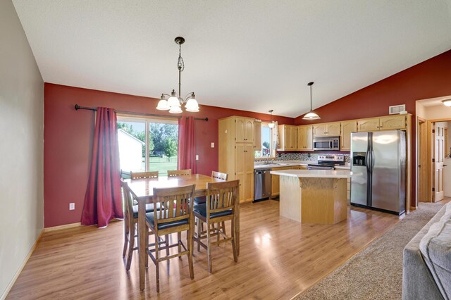 12966 Carole Dr, Becker, MN 55308 - dining room with a chandelier, light wood-style flooring, and lofted ceiling