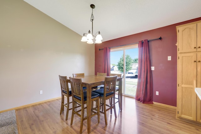 12966 Carole Dr, Becker, MN 55308 - dining room featuring a chandelier, light wood-type flooring, and lofted ceiling