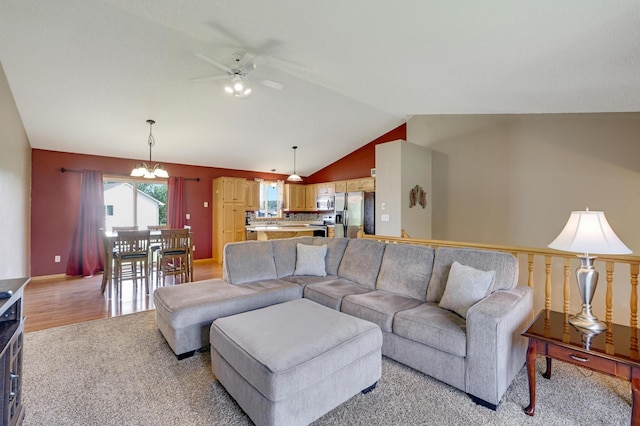 12966 Carole Dr, Becker, MN 55308 - living area featuring vaulted ceiling, ceiling fan, light carpet, and a chandelier