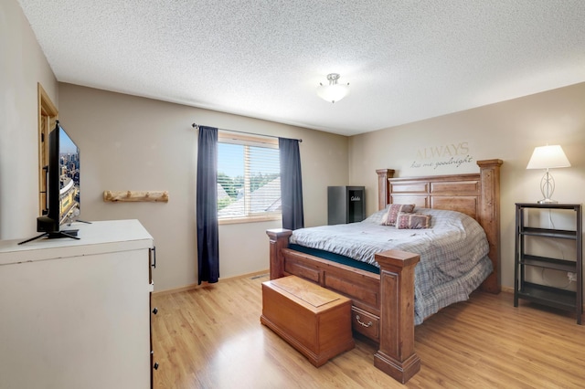12966 Carole Dr, Becker, MN 55308 - bedroom featuring light wood-type flooring and a textured ceiling