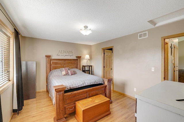 12966 Carole Dr, Becker, MN 55308 - bedroom featuring light wood-style flooring and a textured ceiling