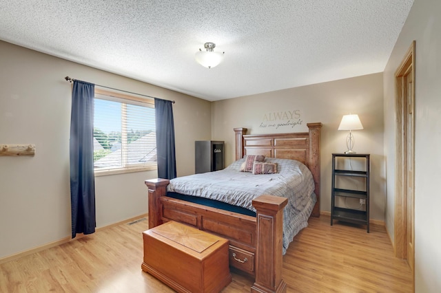 12966 Carole Dr, Becker, MN 55308 - bedroom with light wood finished floors and a textured ceiling