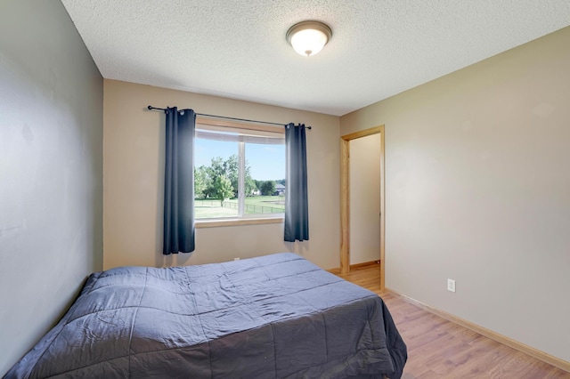 12966 Carole Dr, Becker, MN 55308 - bedroom featuring light wood-style floors and a textured ceiling