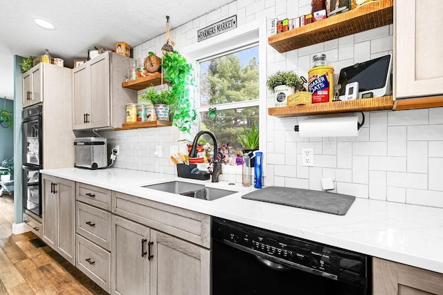 2541 County Road 4, Carlton, MN 55718 - kitchen featuring open shelves, dishwasher, a sink, decorative backsplash, and light countertops