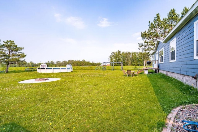 2541 County Road 4, Carlton, MN 55718 - view of grassy yard with a fire pit and a pool