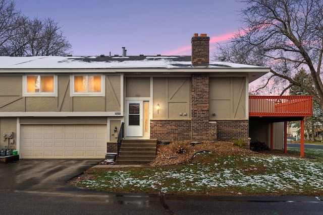 7511 Zinnia Way, Maple Grove, MN 55311 - view of front facade featuring brick siding, an attached garage, a chimney, asphalt driveway, and stucco siding