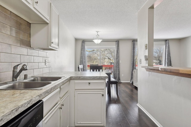 7511 Zinnia Way, Maple Grove, MN 55311 - kitchen with a sink, dishwasher, a peninsula, light countertops, and a textured ceiling