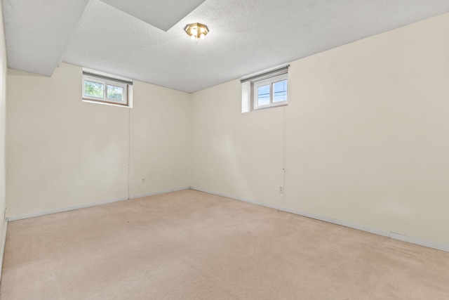 3932 Louisiana Ave N, New Hope, MN 55427 - below grade area featuring light carpet, healthy amount of natural light, baseboards, and a textured ceiling