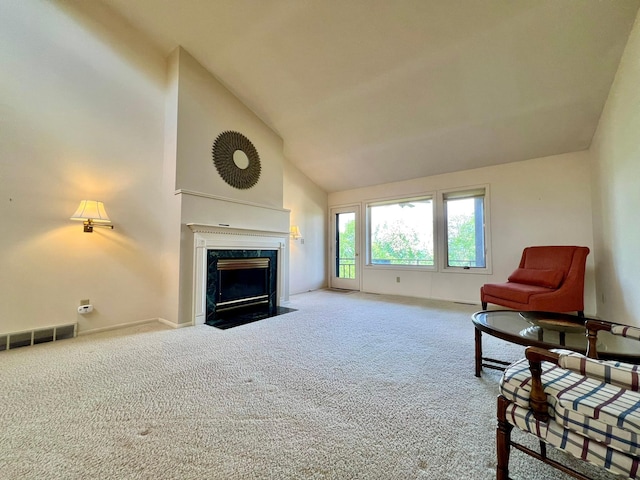 1319 3rd St, Red Wing, MN 55066 - living area with carpet floors, a premium fireplace, baseboards, and high vaulted ceiling