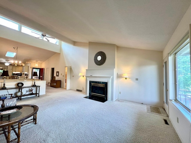 1319 3rd St, Red Wing, MN 55066 - living room with light carpet, a fireplace, high vaulted ceiling, and baseboards