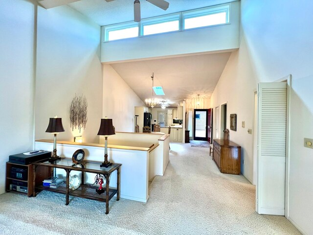 1319 3rd St, Red Wing, MN 55066 - living area with a towering ceiling, light carpet, a ceiling fan, and a chandelier