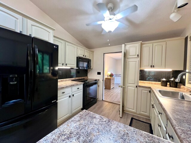 1319 3rd St, Red Wing, MN 55066 - kitchen featuring black appliances, a sink, ceiling fan, vaulted ceiling, and backsplash