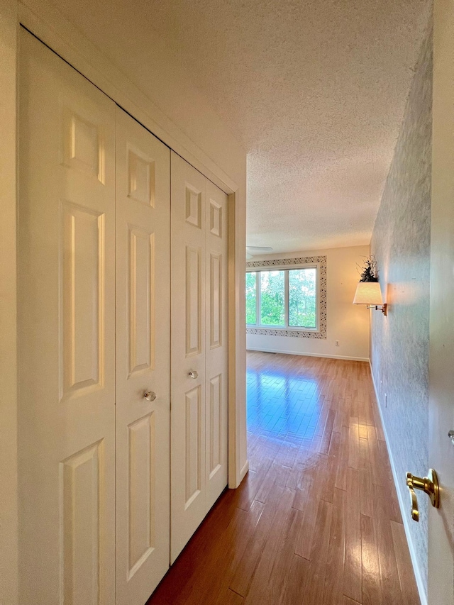 1319 3rd St, Red Wing, MN 55066 - hall featuring wood finished floors, baseboards, and a textured ceiling