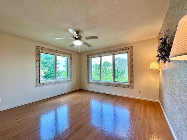 1319 3rd St, Red Wing, MN 55066 - spare room with baseboards, a ceiling fan, a textured ceiling, and wood finished floors