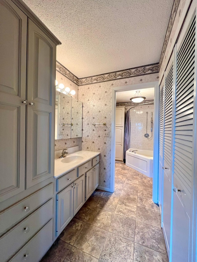 1319 3rd St, Red Wing, MN 55066 - full bathroom with a textured ceiling, vanity, shower / washtub combination, wallpapered walls, and a closet