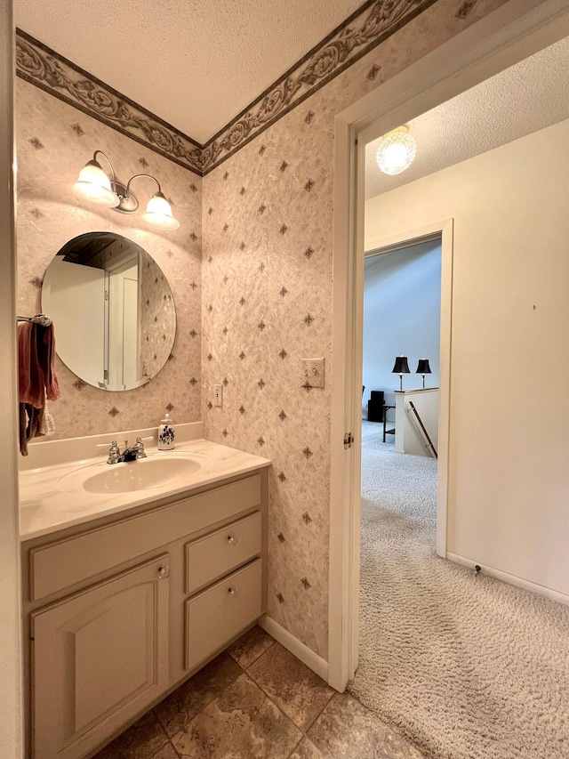 1319 3rd St, Red Wing, MN 55066 - bathroom featuring a textured ceiling, vanity, baseboards, and wallpapered walls
