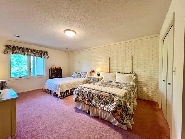1319 3rd St, Red Wing, MN 55066 - carpeted bedroom with brick wall, a textured ceiling, a closet, and baseboards