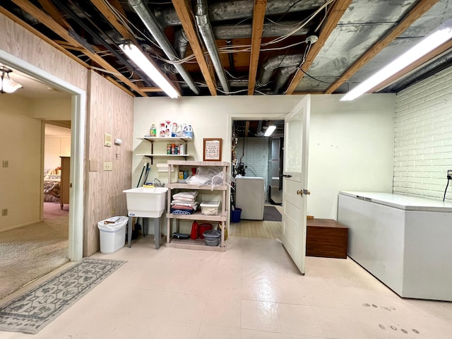 1319 3rd St, Red Wing, MN 55066 - basement featuring white fridge, washer / dryer, and a sink