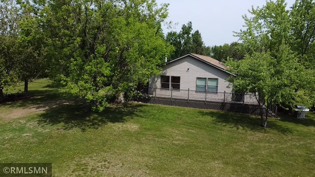 26612 State Highway 47, Aitkin, MN 56431 - view of side of home featuring a wooden deck and a lawn