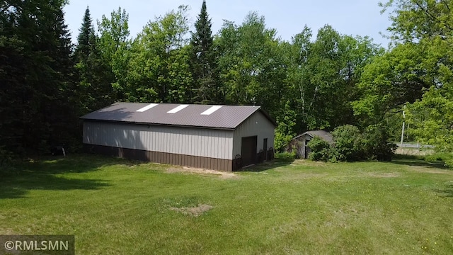 26612 State Highway 47, Aitkin, MN 56431 - view of side of property featuring a yard, an outdoor structure, a pole building, and metal roof