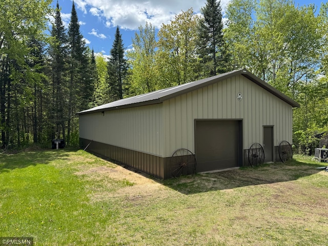 26612 State Highway 47, Aitkin, MN 56431 - view of side of home with a detached garage, a lawn, an outdoor structure, and board and batten siding