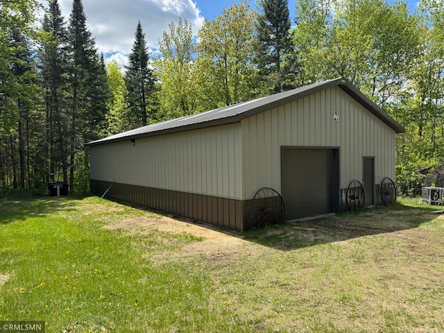 26612 State Highway 47, Aitkin, MN 56431 - view of property exterior featuring a lawn, a detached garage, an outdoor structure, and board and batten siding