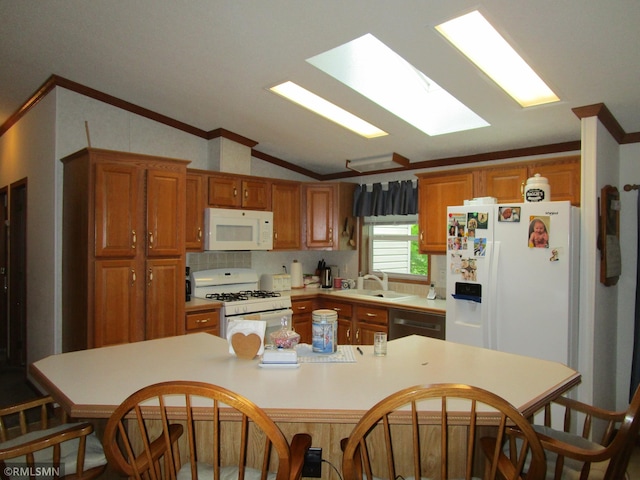 26612 State Highway 47, Aitkin, MN 56431 - kitchen featuring white appliances, crown molding, vaulted ceiling, a kitchen bar, and a sink
