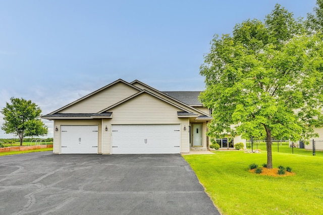 918 Mallard St NE, Hanover, MN 55341 - view of front facade featuring asphalt driveway, a front lawn, roof with shingles, and a garage
