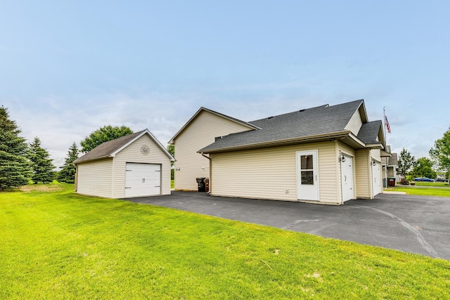 918 Mallard St NE, Hanover, MN 55341 - view of side of home with an outdoor structure, a yard, a shingled roof, and a garage