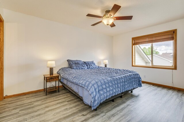 918 Mallard St NE, Hanover, MN 55341 - bedroom featuring light wood-style flooring, baseboards, and a ceiling fan