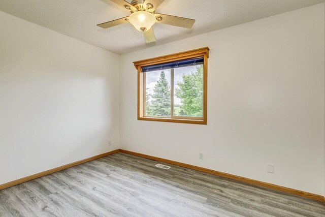 918 Mallard St NE, Hanover, MN 55341 - empty room with light wood-style floors, baseboards, and a ceiling fan