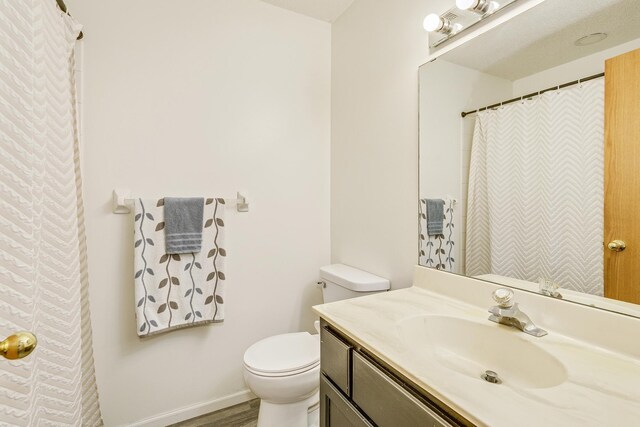 918 Mallard St NE, Hanover, MN 55341 - full bathroom with toilet, vanity, wood finished floors, and baseboards