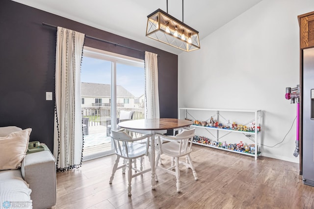 934 31st Ave W, West Fargo, ND 58078 - dining room featuring light wood-type flooring, baseboards, and lofted ceiling