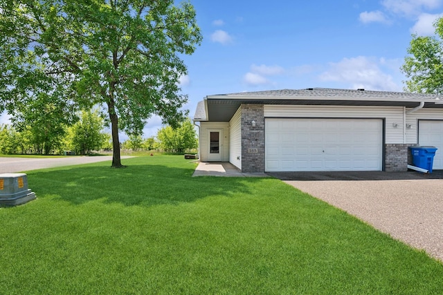 185 21st Ave SW, Cambridge, MN 55008 - view of front of home with a front yard, brick siding, asphalt driveway, and a garage