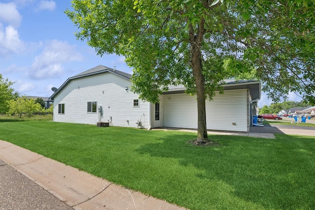185 21st Ave SW, Cambridge, MN 55008 - view of home's exterior featuring a lawn and central AC