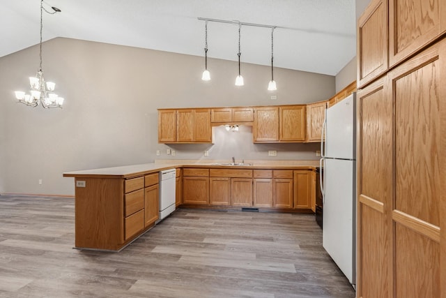 185 21st Ave SW, Cambridge, MN 55008 - kitchen with white appliances, a peninsula, a sink, a chandelier, and light wood-style floors