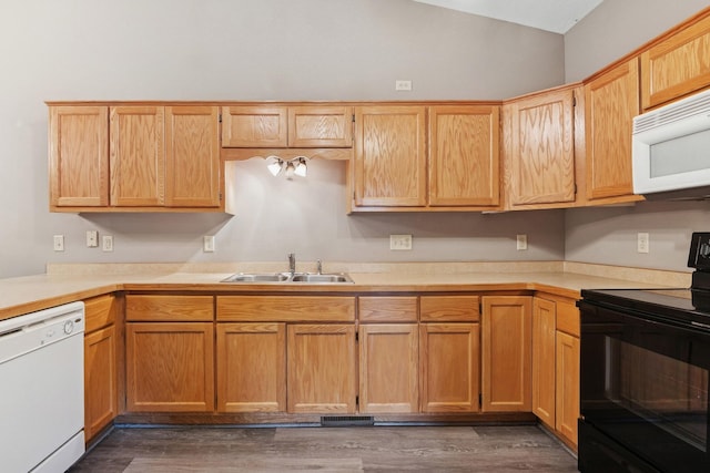 185 21st Ave SW, Cambridge, MN 55008 - kitchen featuring white appliances, a sink, light countertops, wood finished floors, and vaulted ceiling