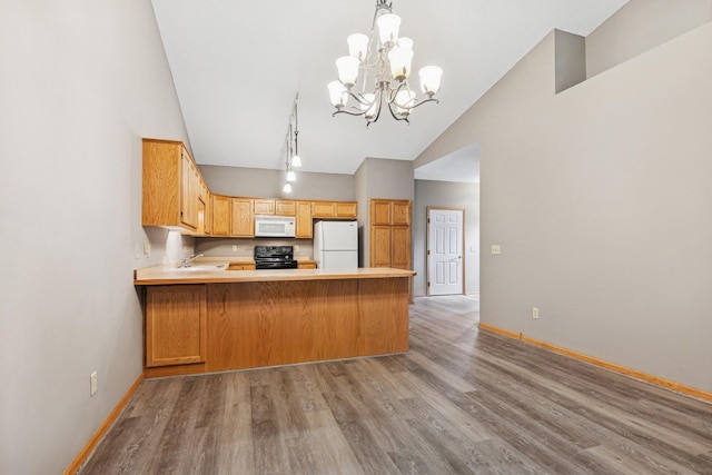 185 21st Ave SW, Cambridge, MN 55008 - kitchen with white appliances, a chandelier, baseboards, light countertops, and high vaulted ceiling