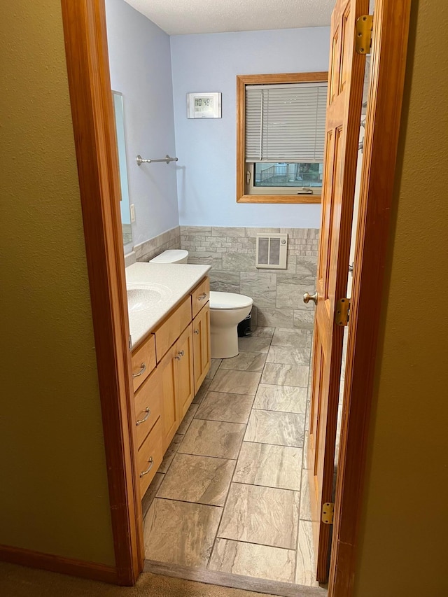 1602 8th Ave S, Saint Cloud, MN 56301 - bathroom with vanity, tile walls, and wainscoting