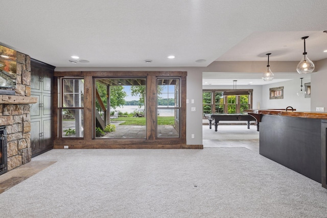 3920 Hawthorne Cir, Chanhassen, MN 55331 - living room with a stone fireplace, light carpet, pool table, recessed lighting, and bar